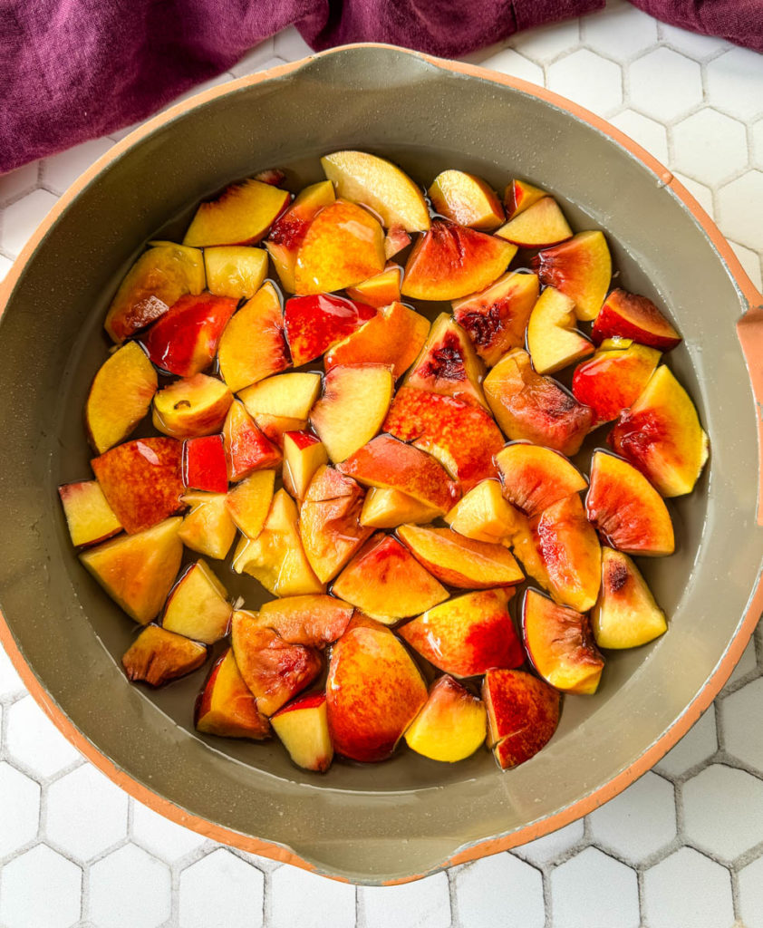 diced peaches and homemade simple syrup in a skillet