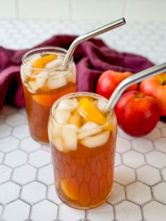 Southern sweet peach tea in glasses with a straw