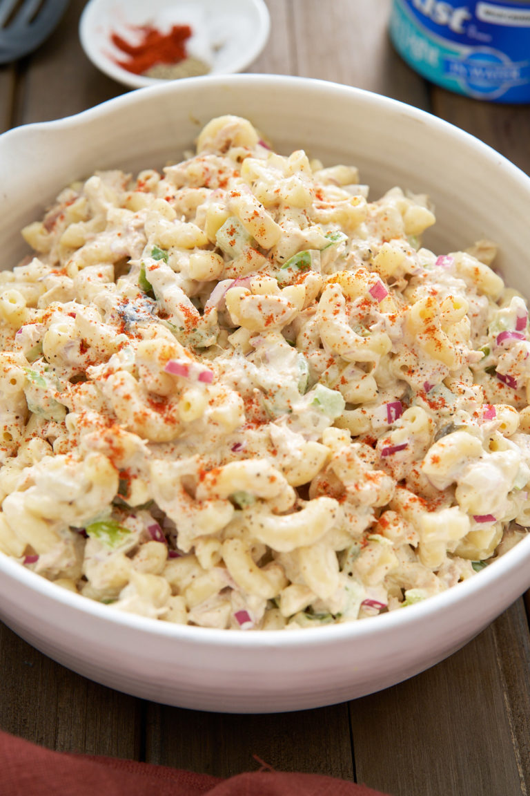 tuna macaroni salad in white bowl on wooden table