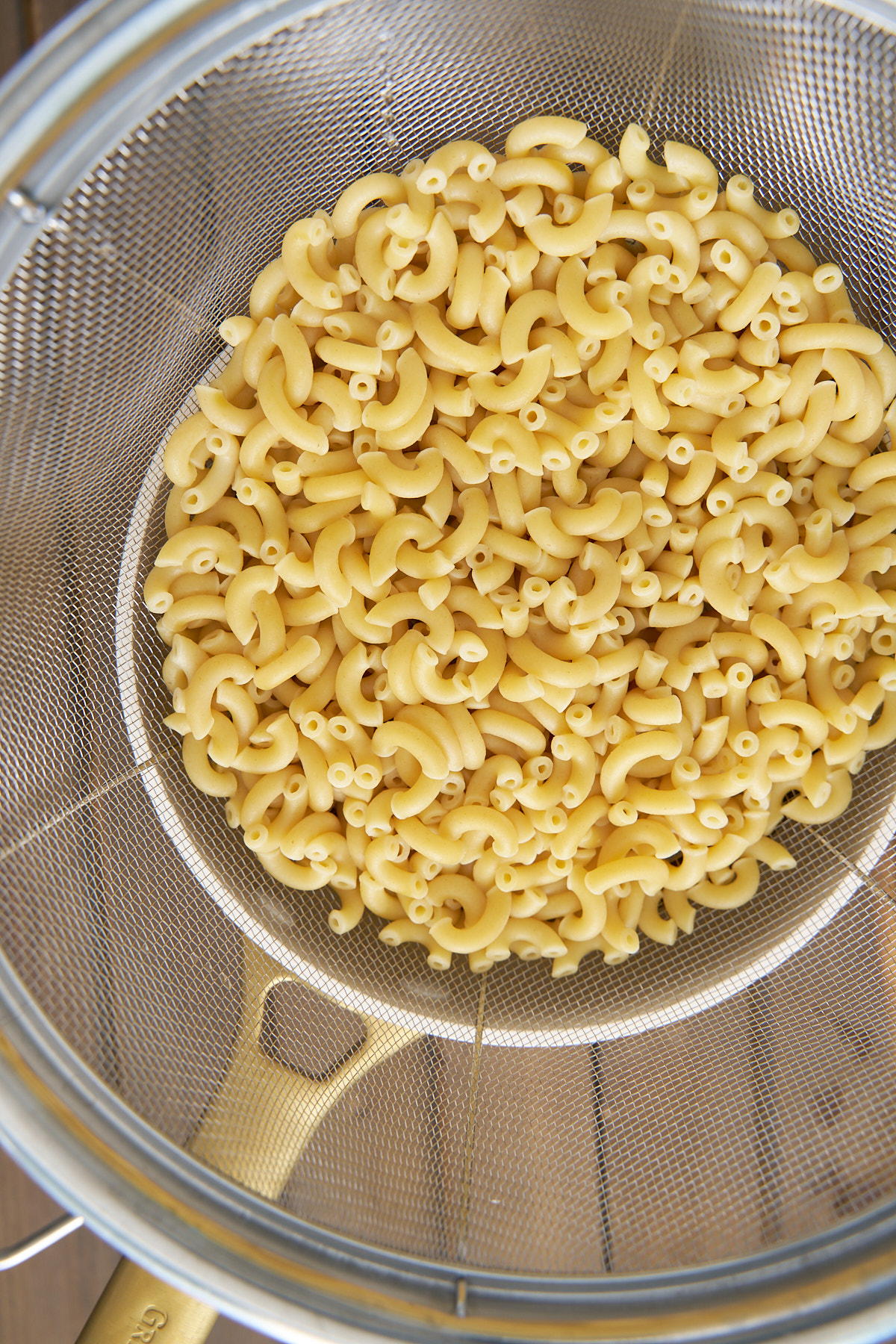 pasta being drained for tuna macaroni salad