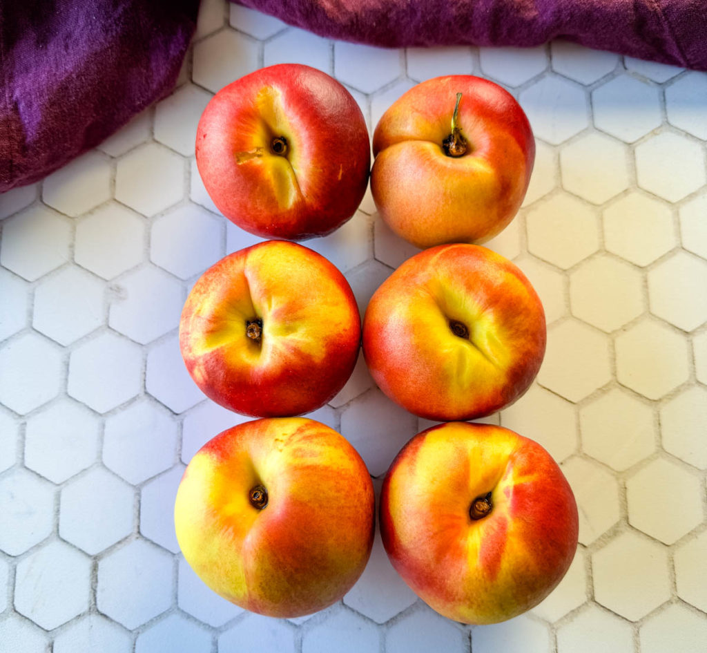 fresh peaches on a flat surface