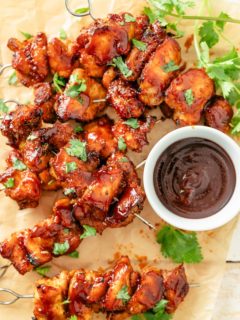 Juicy chicken skewers with a crispy crust, ready for dipping in BBQ sauce.