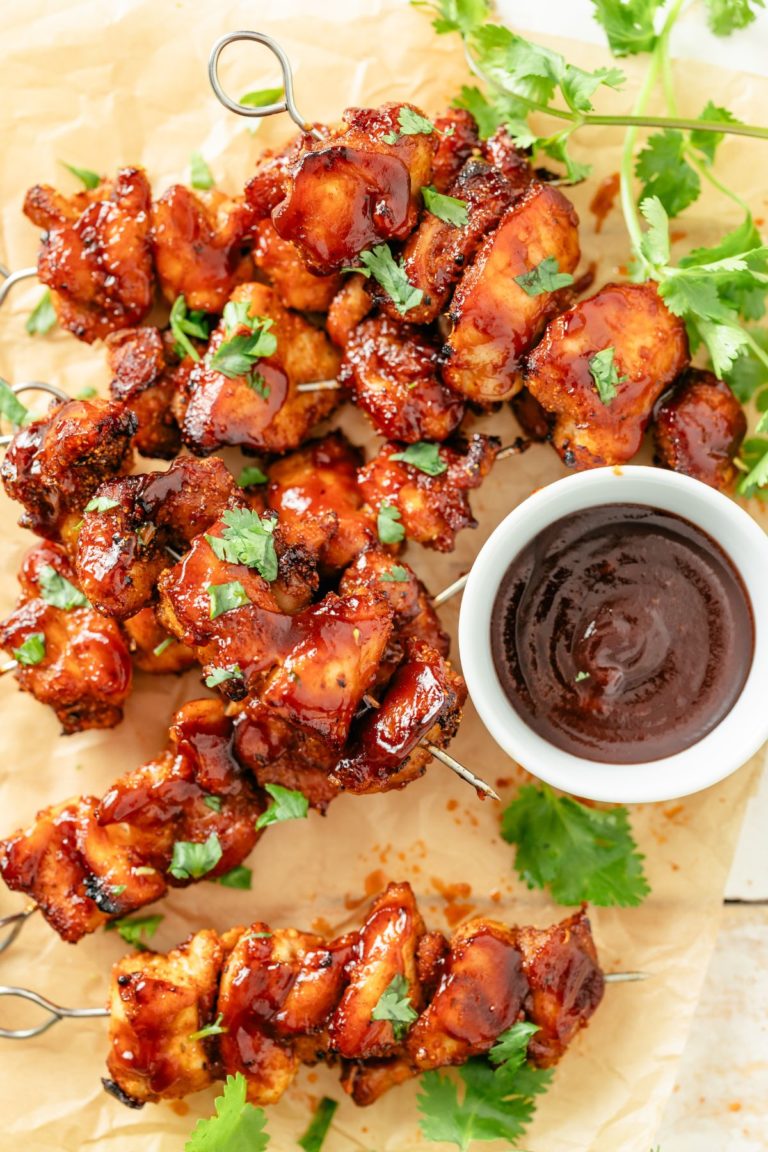Juicy chicken skewers with a crispy crust, ready for dipping in BBQ sauce.