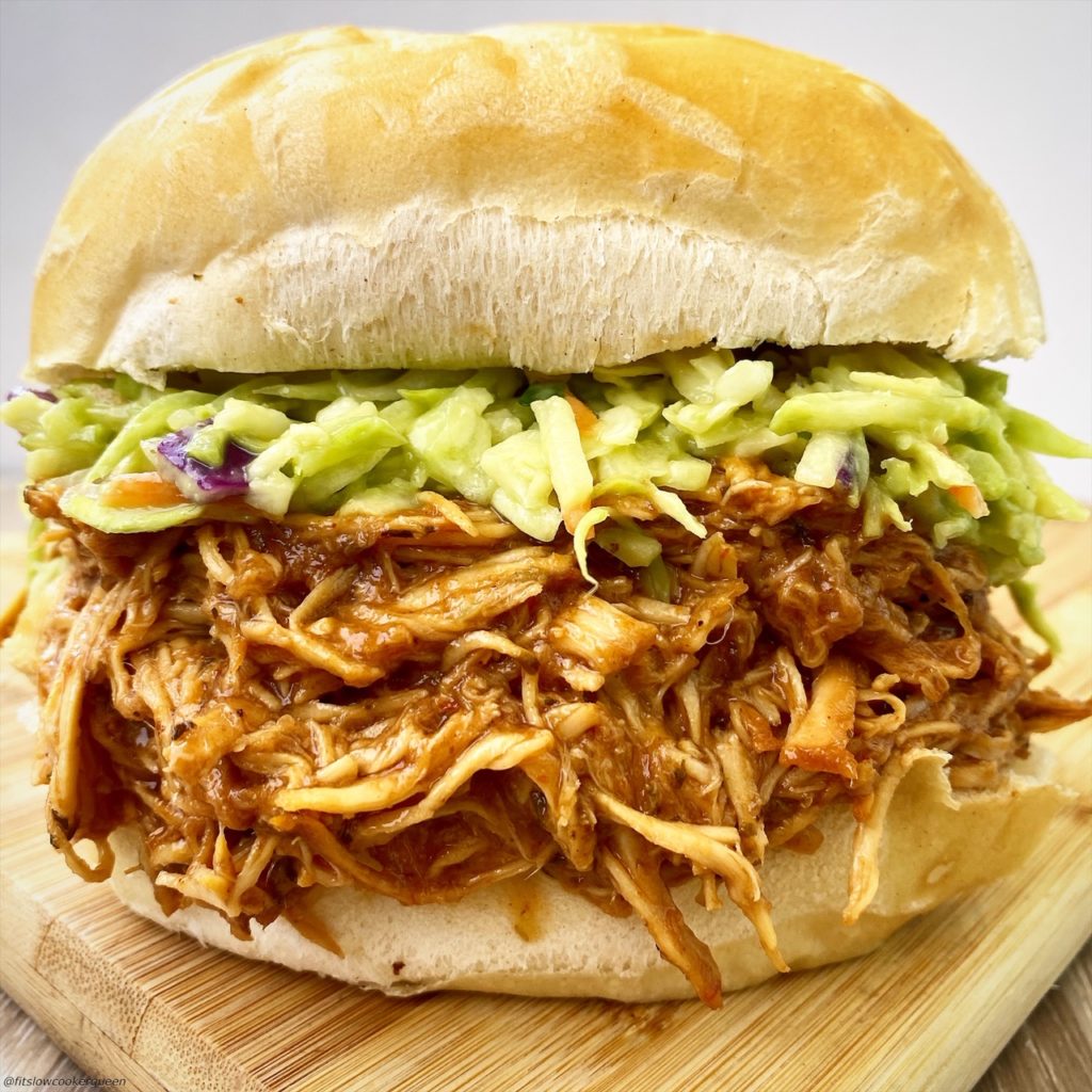 bbq pulled chicken topped with slaw on a bun