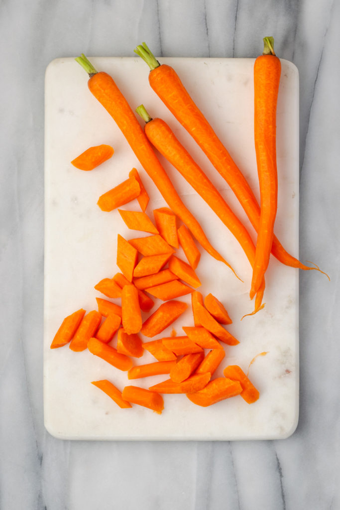 Overhead view of carrots cut on board