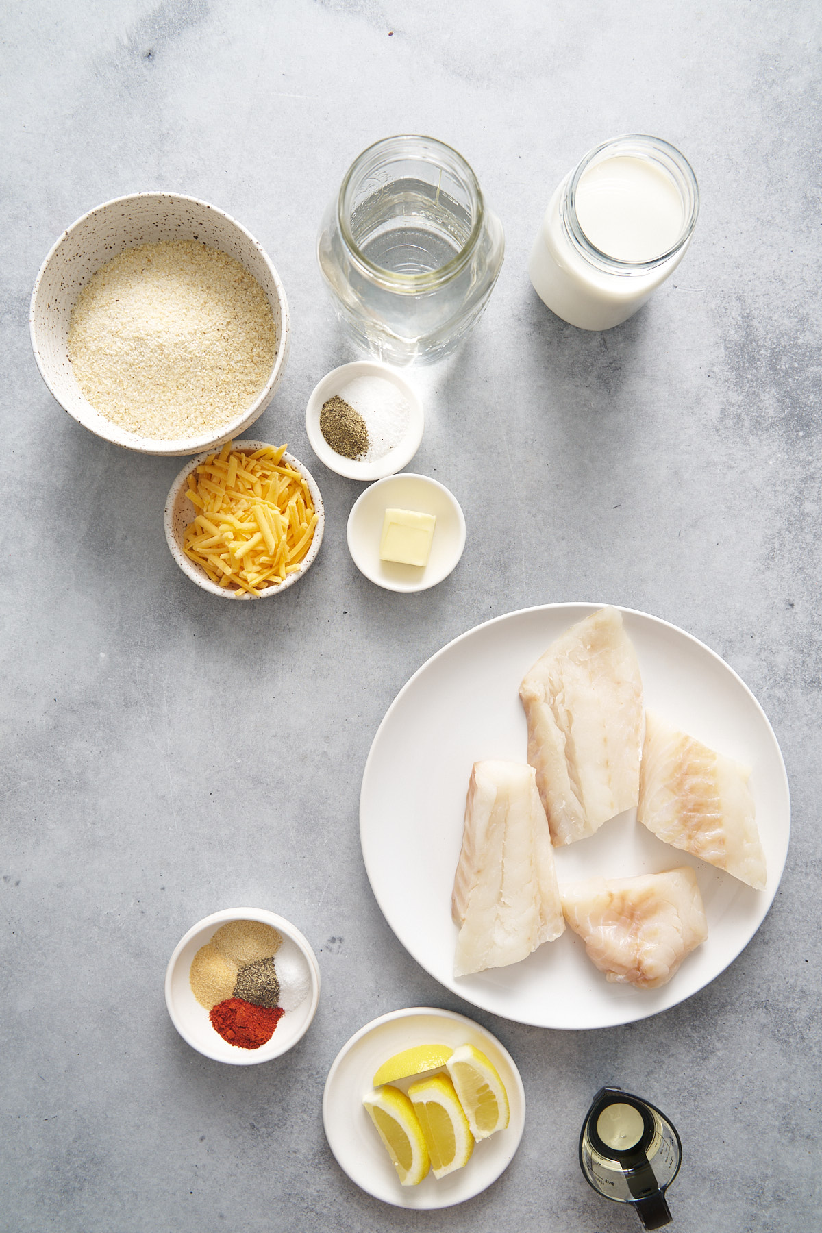 the ingredients for fish and grits on a table