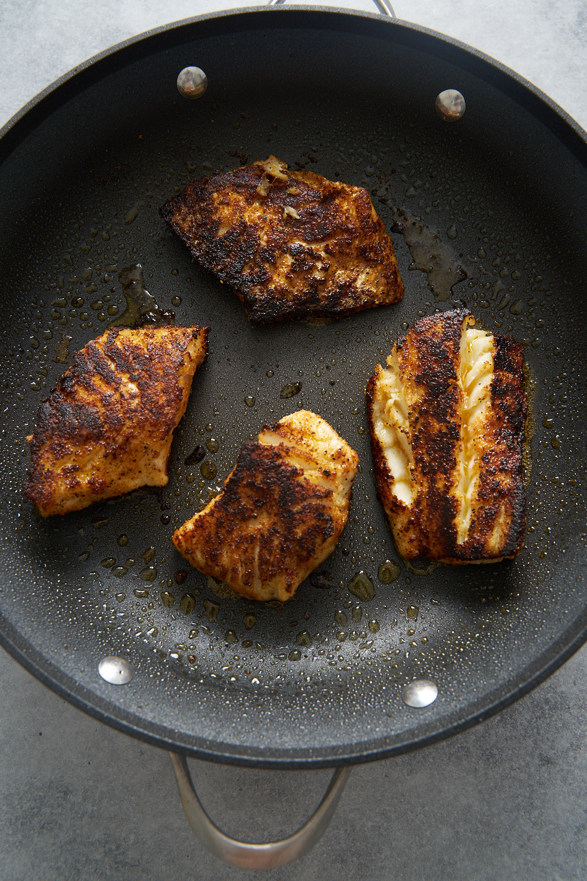 cooked fish filets in a skillet