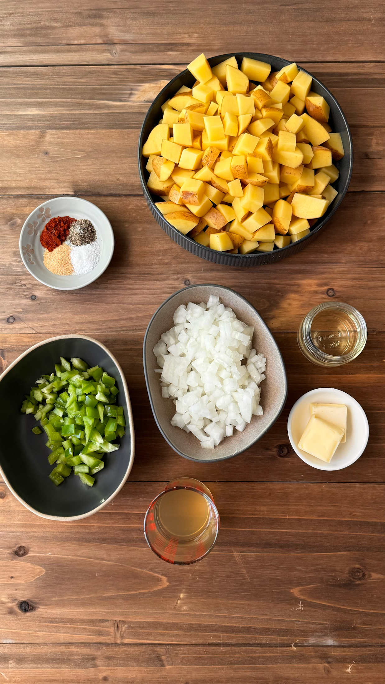 ingredients for smothered potatoes on table in separate bowls