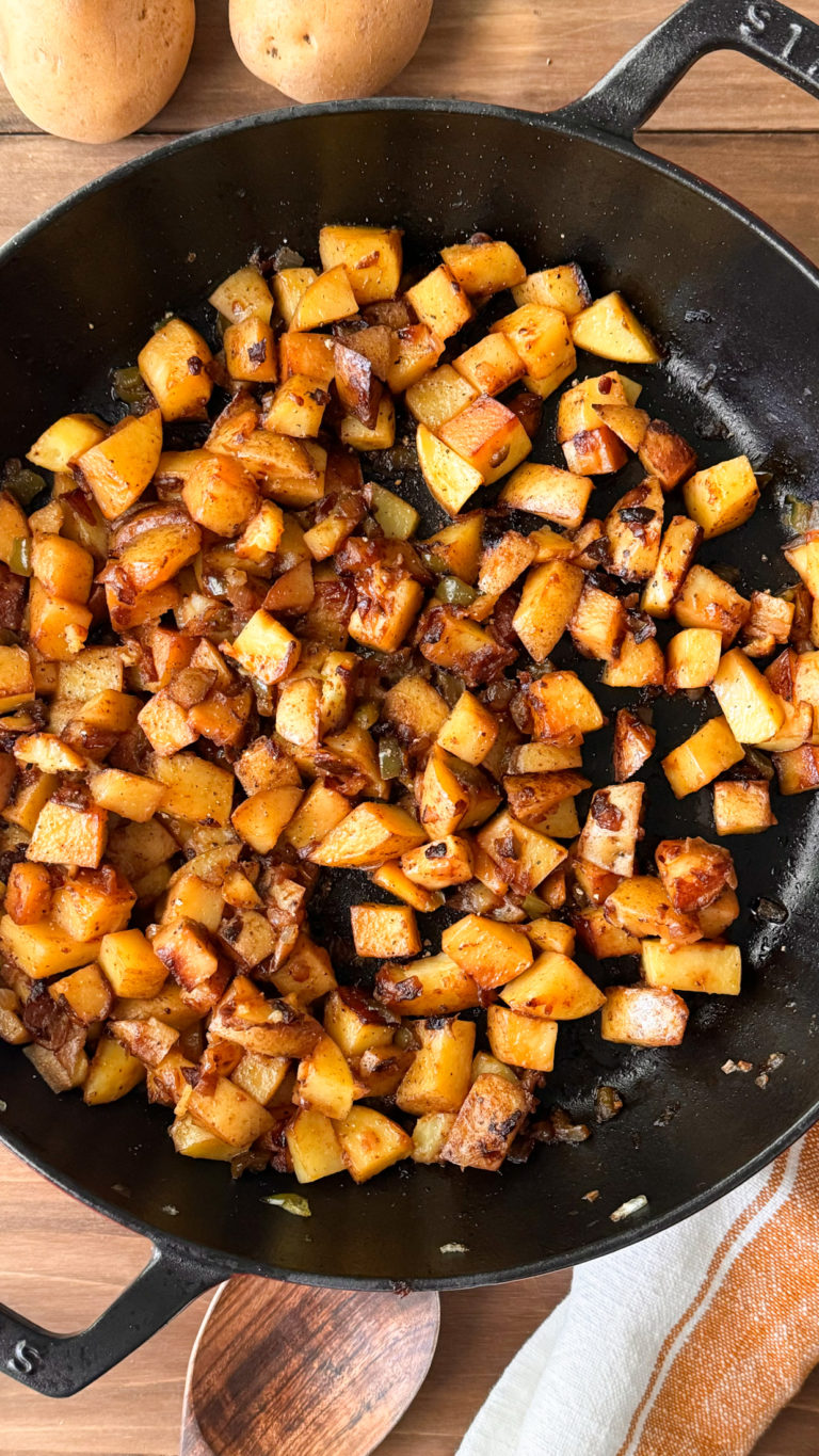 smothered potatoes in cast iron skillet on table