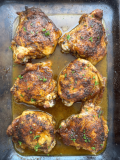 overhead shot of cooked baked chicken in a glass dish