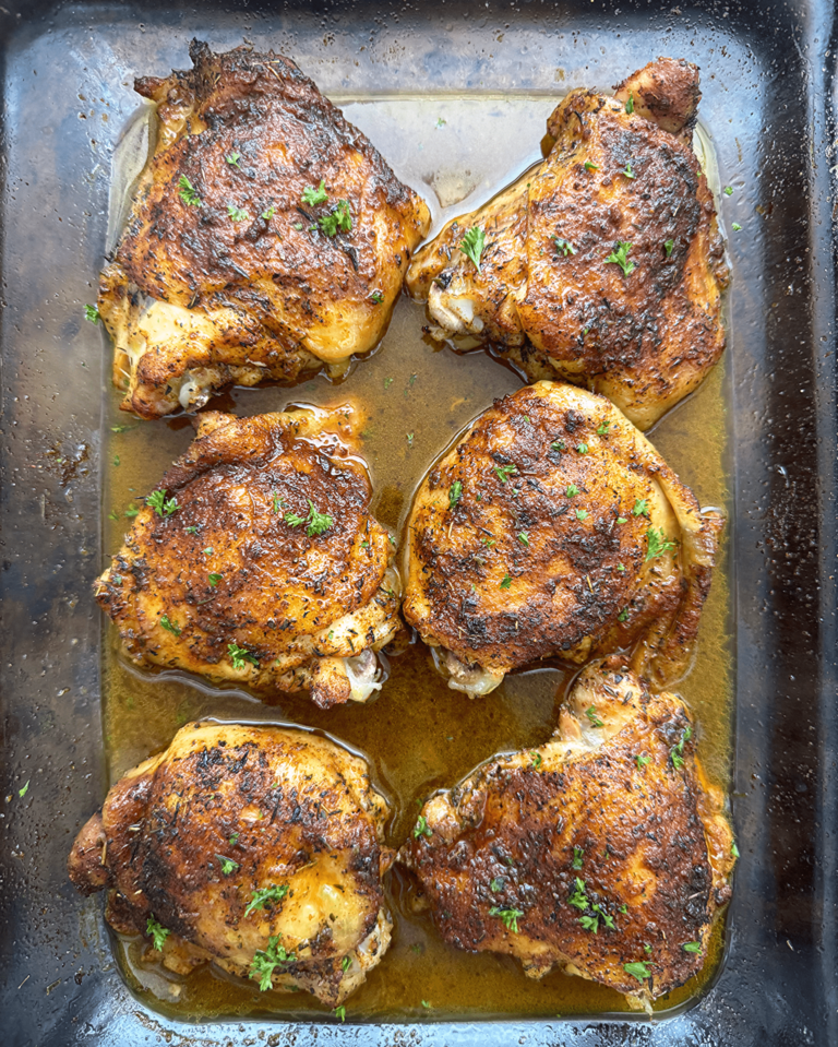overhead shot of cooked baked chicken in a glass dish