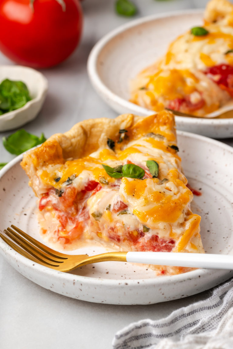 Slice of Southern tomato pie on plate with fork