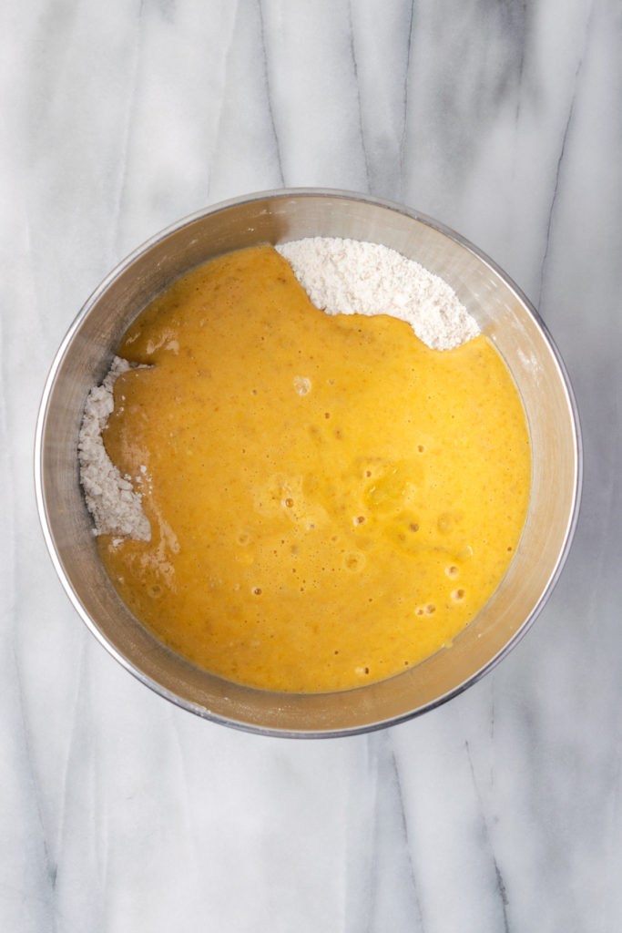 Overhead view of liquid and dry ingredients combined in mixing bowl