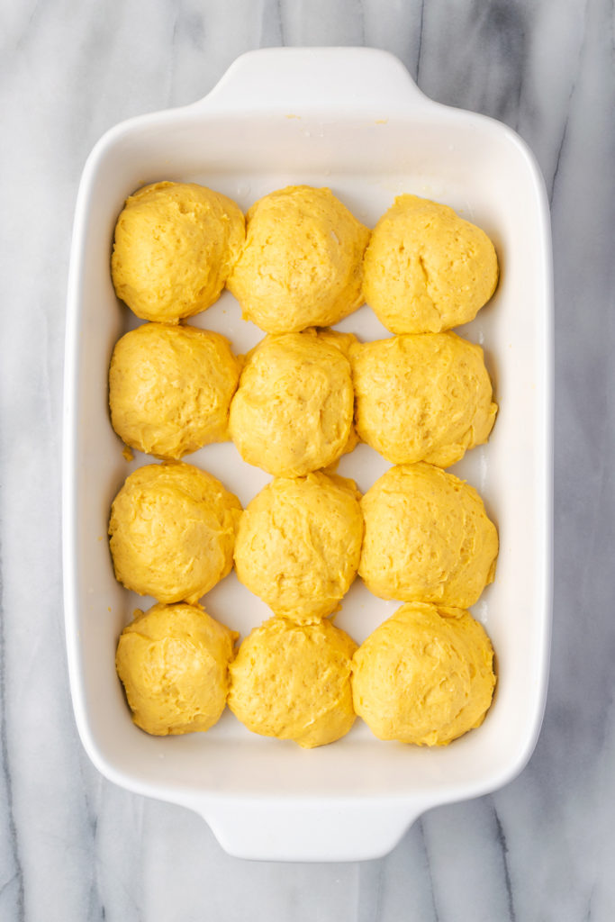 Overhead view of sweet potato roll dough in baking dish before rising