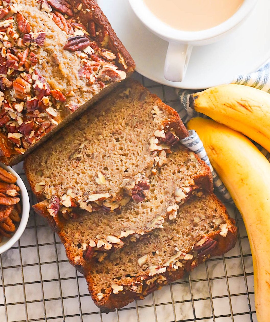 Decadent banana bread with nuts and a steaming cup of coffee