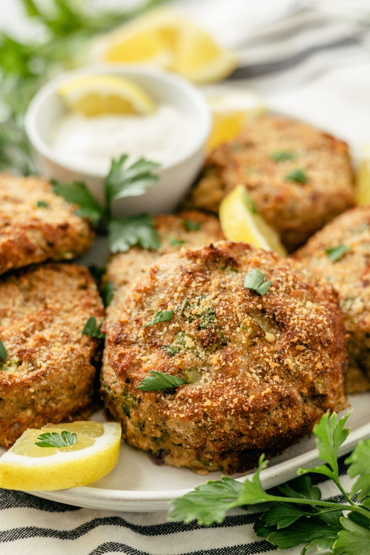 Crispy salmon patties made with canned salmon, served with a side of mayo dip.