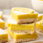 Stack of 3 lemon bars on wooden board