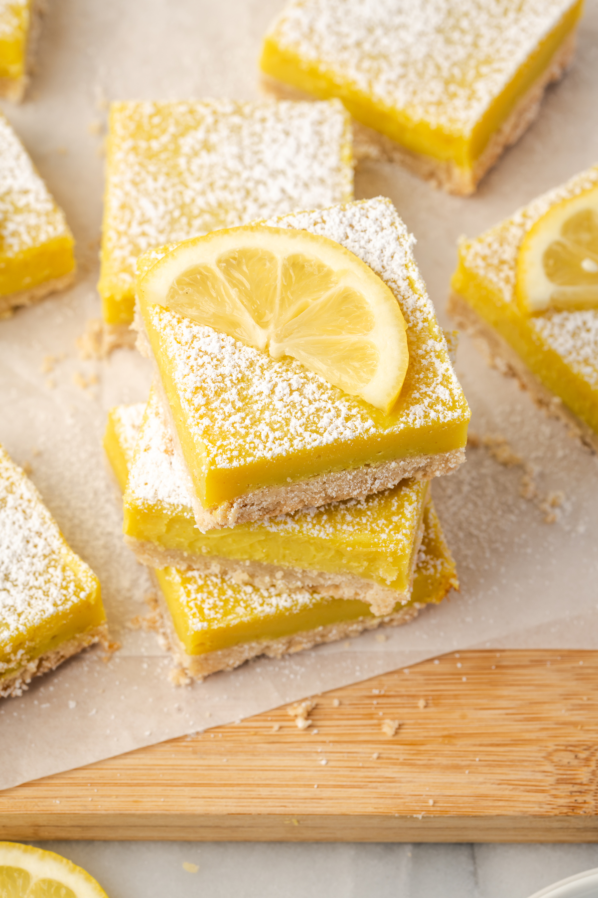 Top-down view of stacked lemon bars with lemon wedge on top