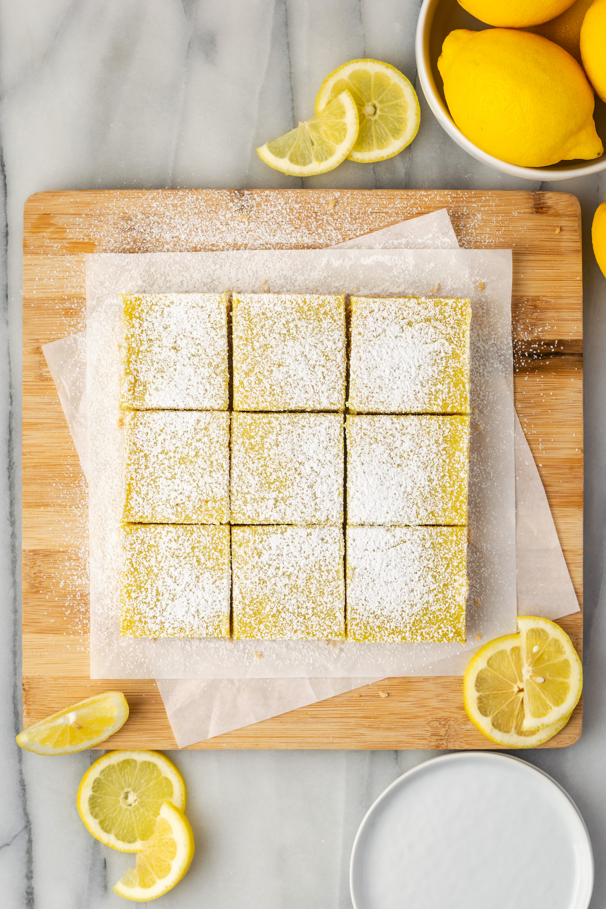 Overhead view of cut lemon bars with powdered sugar