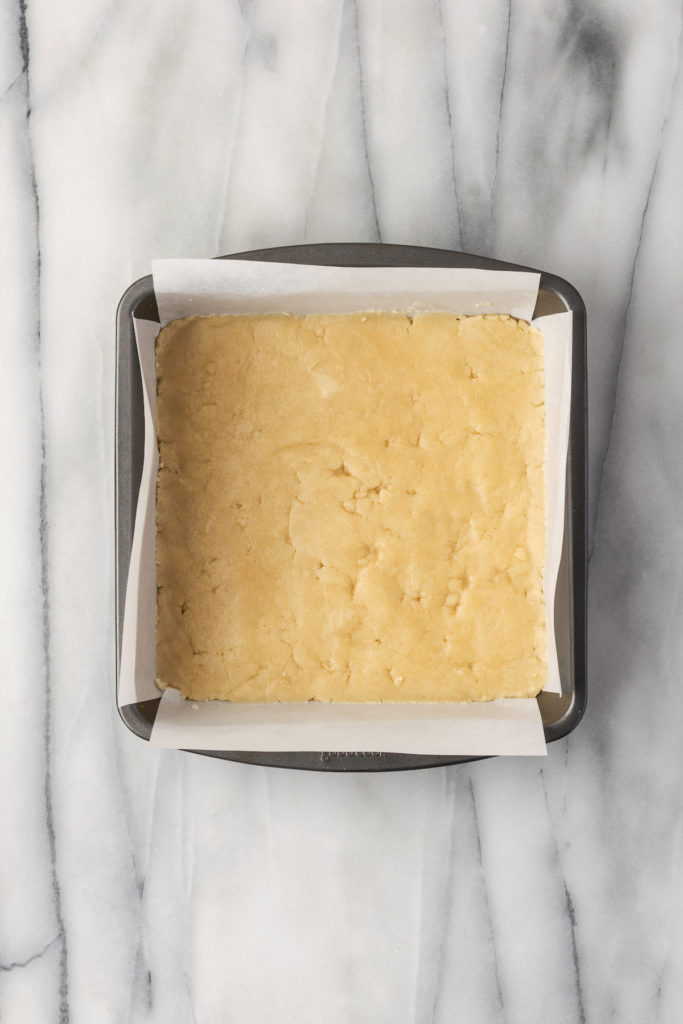 Overhead view of crust for lemon bars in pan