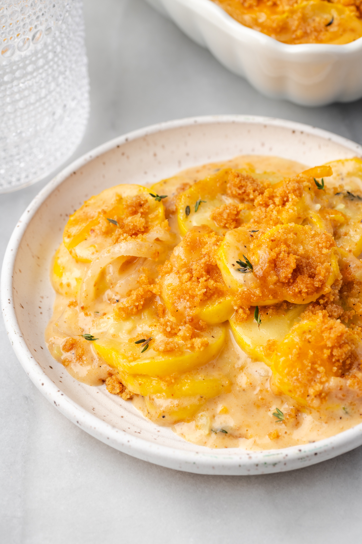 Plate of squash casserole with breadcrumb topping