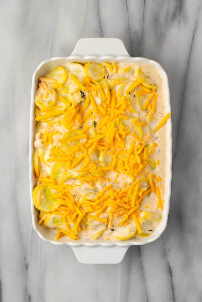 Overhead view of squash casserole with cheese on top